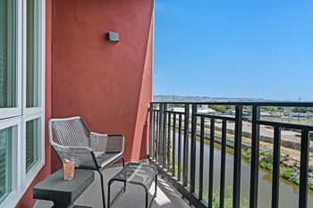 a balcony with two chairs and a coffee table